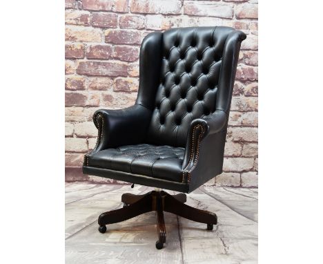 NORWEGIAN LEATHER DESK CHAIR, button upholstered in black with swivel base Condition: arms and seat worn.