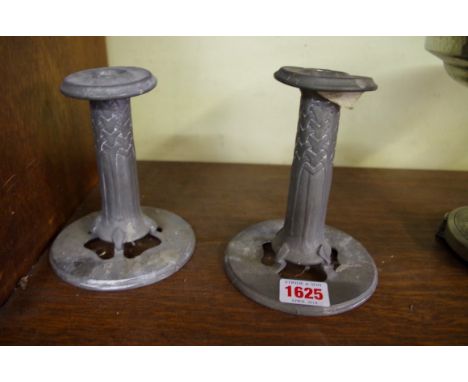 A rare pair of Liberty 'Tudric' pewter candlesticks, No. 022, 13.5cm high.