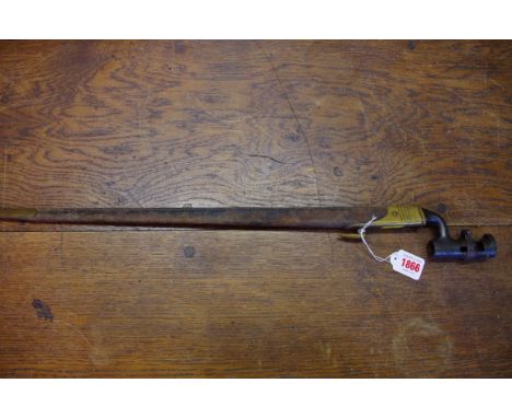 An antique bayonet and brass mounted leather scabbard, with triangular section blade.  Condition Report: Quite a lot of rusti