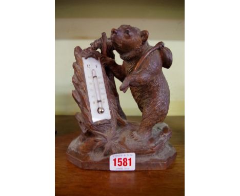 A Black Forest carved wood bear thermometer, 18.5cm high.    Condition Report:  Chip to ear.Chip to top of the branch.Chip to