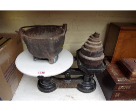 A set of cast iron kitchen scales, with weights; together with a crucible.