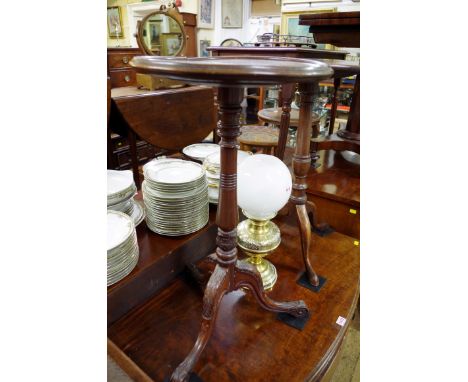 An antique carved mahogany tripod table, with circular dished top, 40cm diameter. 