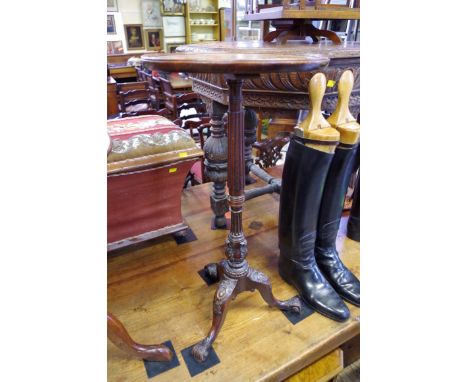 An antique carved mahogany tripod table, with dished circular top, 36cm diameter. 