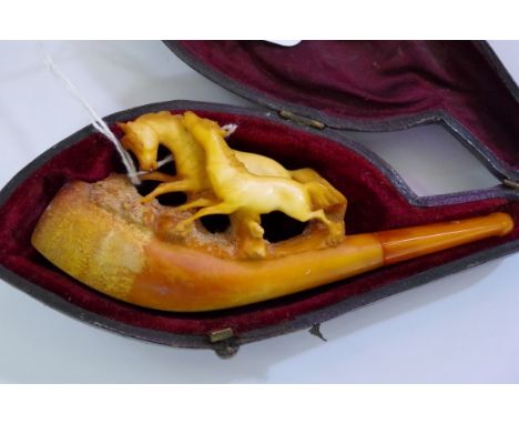 A carved meerschaum pipe, with amber mouth piece in fitted case, 