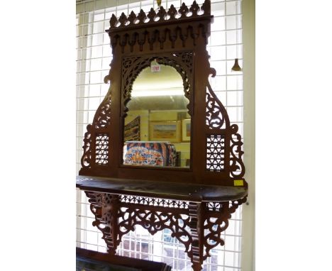 An Ottoman style carved hardwood framed wall mirror, 87 x 59cm.  Condition Report: A piece of pierced moulding missing from m