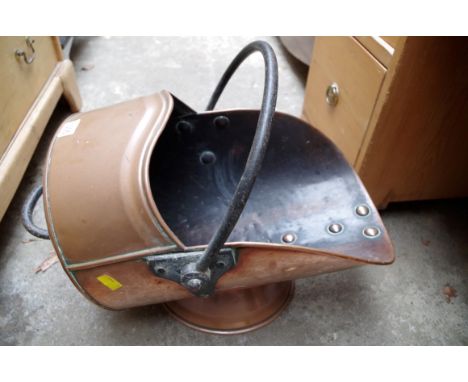 An old brass coal scuttle, stamped with broad arrow and 'WD'.