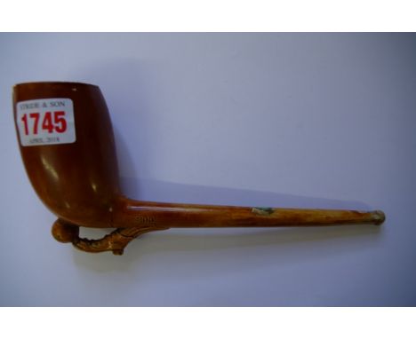 A novelty clay pipe, moulded with a soccer ball and boot, labelled 'Briarite, M D & Co', 22cm long.  