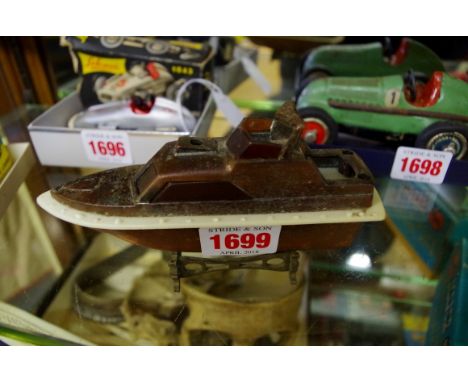 A vintage novelty motor launch lighter, 14cm long, on stand. 