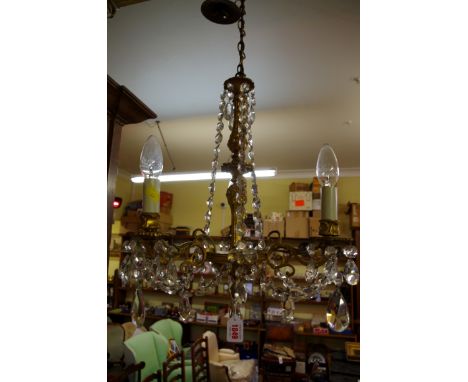 A brass and faceted glass drop three branch ceiling light. 