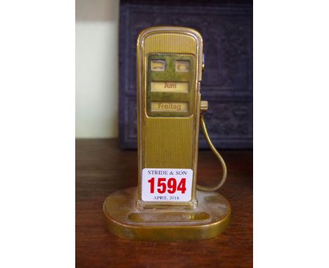 A vintage German brass novelty petrol pump combined desk calendar and lighter, 12cm high.
