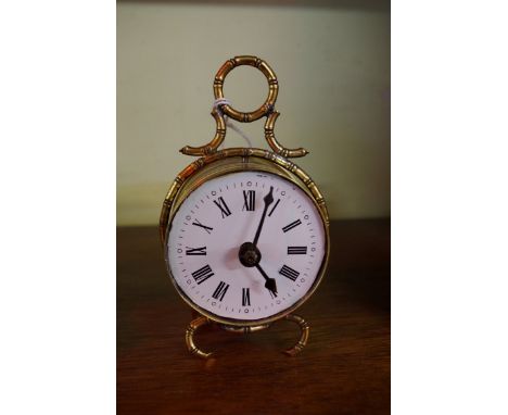 An antique Continental brass alarm clock, 12.5cm high. 