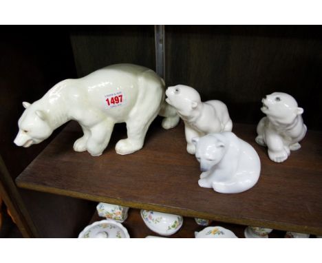 A Melba ware polar bear; together with two USSR porcelain polar bears; and another Lladro example. 