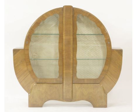 An Art Deco walnut globe display cabinet,with a pair of centre hinged doors, with rounded front edge glass shelves,134cm wide