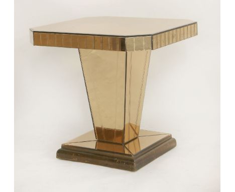 An Art Deco mirrored glass lamp table,wtih pink tinted plates, raised on a wood plinth,61cm wide60cm deep59cm high