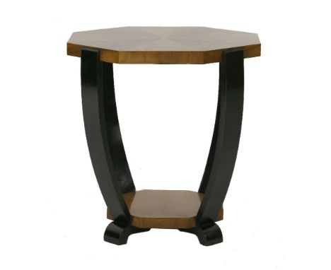 A walnut lamp table,the octagonal segmented top raised on shaped ebonised supports,50cm diameter52.5cm high