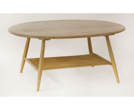 An Ercol coffee table,with a shaped top, over a turned undertier,100cm wide