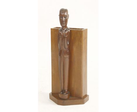 A hardwood stick stand,mounted to the front with a dapper gentleman,78cm high