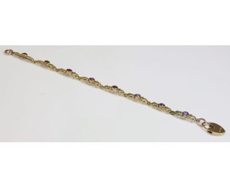 An Art Nouveau gold amethyst bracelet,by Lawson Ward & Gammage.  A series of elongated oval open links, with a circular mixed