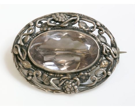 A silver Arts and Crafts single stone quartz brooch,attributed to Dorrie Nossiter.  A near colourless amethyst, rub set to th