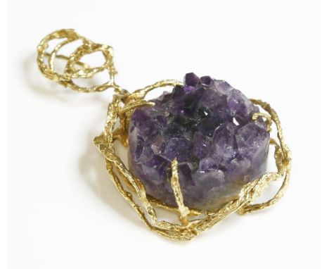 An 18ct gold amethyst geode pendant, c.1970,of open molten form, a circular section of amethyst geode, claw set to an irregul