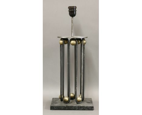 An iron and patinated table lamp base,after a design by Jean Royère,54cm high overallBought in the South of France and, by re