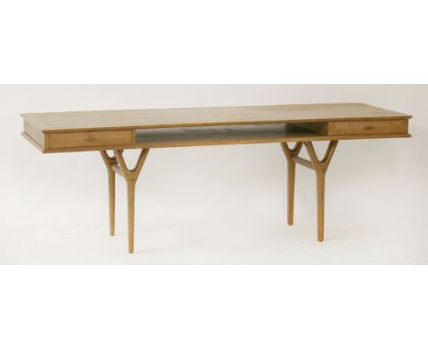 A Danish teak long coffee table,with two sets of drawers each side, flanking a shelf,153cm long52cm wide52cm high