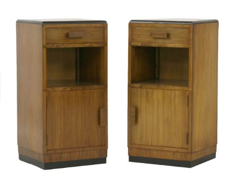 A pair of Art Deco walnut pot cupboards,over a single drawer, shelf and cupboard, raised on an ebonised plinth,35.5cm wide34c