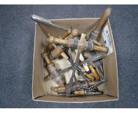 A box containing antique woodworking tools, including chisels, drill bits, etc 
