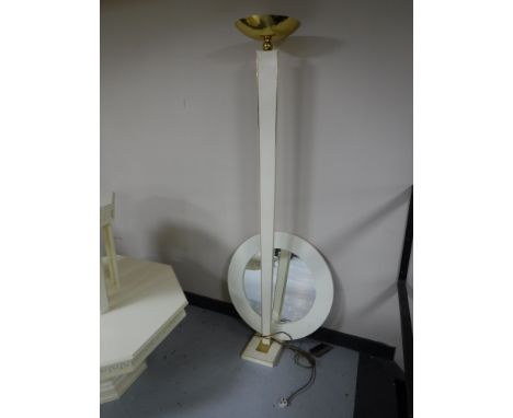 A white and brass up-lighter and a circular white framed mirror 