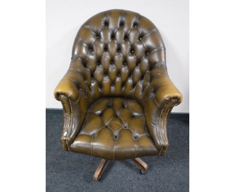A Chesterfield button back tan leather swivel desk chair 