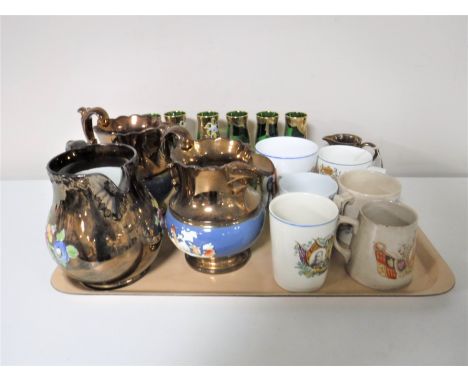 A tray containing late 19th and early 20th century commemorative mugs, four copper lustre jugs, Victorian green glass sugar b