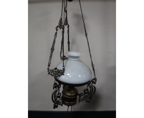 An antique rise and fall oil lamp with glass shade (converted)