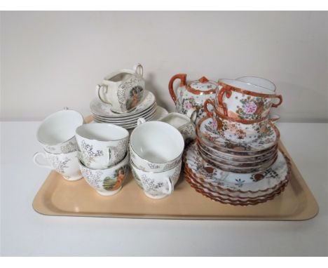 A tray containing a fourteen piece Japanese tea service together with an English china tea service