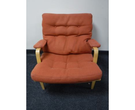 A beech framed armchair, upholstered in a button fabric