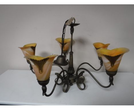 A brass five way light fitting with glass shades