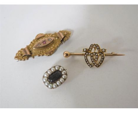 A Georgian pearl memorial brooch, a 15ct gold seed pearl brooch and a 9ct gold ruby and diamond brooch
