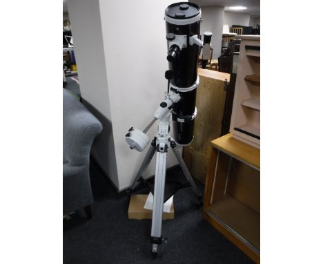 A Skywatcher reflector telescope on stand with instructions and a box containing Barlow lenses 