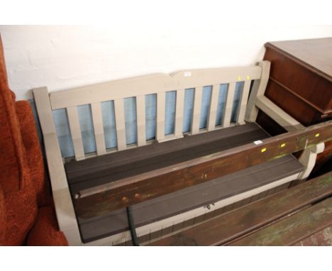 A PLASTIC GARDEN BENCH WITH BUILT-IN STORAGE UNIT