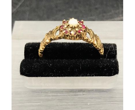 A 9 ct yellow gold seed pearl and garnet ring