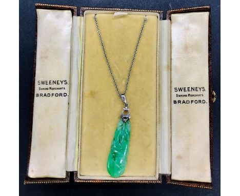 A Jade pendant on 9 ct white gold chain and mount.