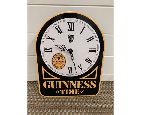 An enamel Guinness promotional wall clock