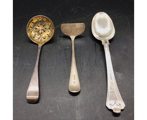 Three assorted silver items, spoon, sugar sifter and a child's food pusher.