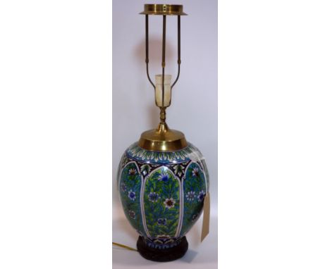 An early 20th century Turkish blue glazed vase converted to a lamp, with vignettes of flowers, on hardwood base, no shade, H.