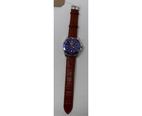 A Gentleman's Invicta stainless steel and gilt metal wristwatch with navy blue dial and outer bezel, date aperture with gilt 