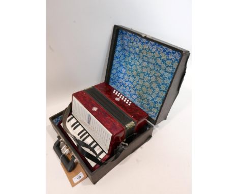 A cased Soviet child's accordion, with Raznoexport label, 'Made in USSR' 