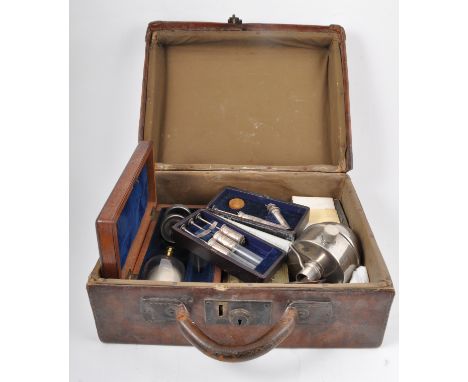 A lined leather Doctor's bag, containing a small collection of antique medical tools.