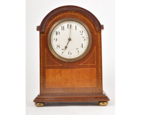 An Edwardian inlaid mahogany mantle clock, white enamelled dial, cylinder movement, 23cm.