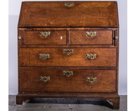George III oak bureau, fall front enclosing a fitted interior, above two short and two long drawers and on bracket feet, widt