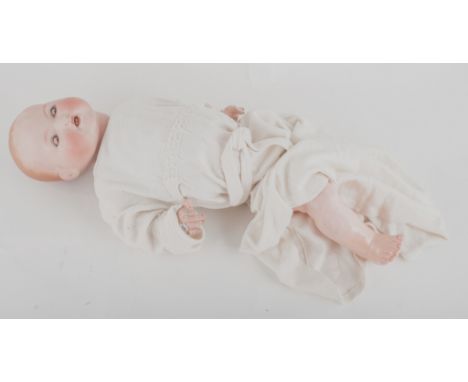 Ceramic head doll, with papier-mache legs, with clothing. 
