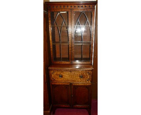 A Regency mahogany narrow secretaire bookcase, having twin lancet glazed upper doors, with two adjustable shelves, over fitte